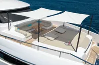 Luxurious 2020 Custom Line Navetta 33 yacht deck with sunbeds and seating area.