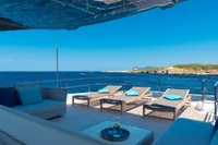 Luxurious 2020 Custom Line Navetta 33 yacht deck with sun loungers and ocean view.