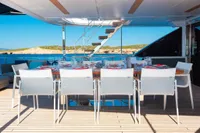 Luxury dining area on 2020 Custom Line Navetta 33 yacht, featuring elegant tableware and ocean view.