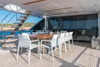 Outdoor dining area on 2020 Custom Line Navetta 33 yacht with ocean view.