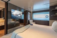 Luxurious bedroom interior on 2020 Custom Line Navetta 33 yacht with modern decor and large windows.