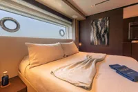 Luxurious bedroom interior on 2020 Custom Line Navetta 33 yacht with modern decor.