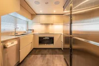 Modern kitchen interior on 2020 Custom Line Navetta 33 yacht, featuring sleek cabinetry and stainless steel appliances.