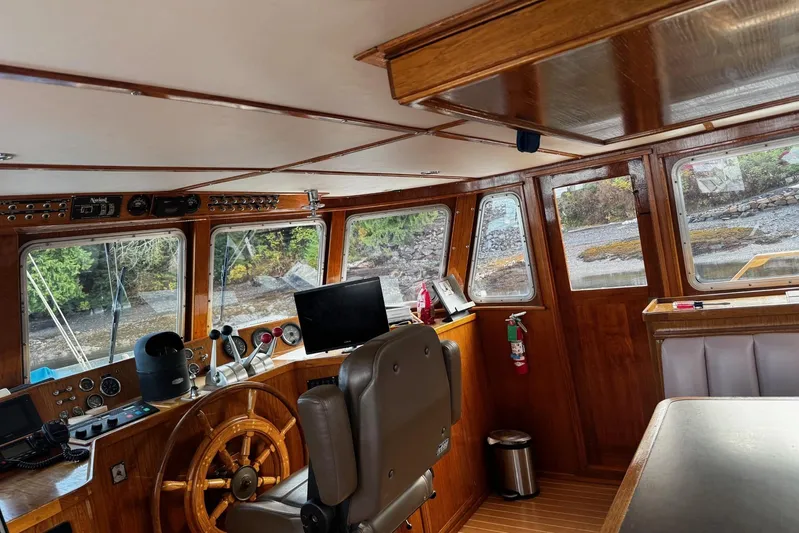Shackleton Yacht Photos Pics 1982 Miller Marine North Sea Trawler interior with wooden helm, navigation equipment, and large windows.
