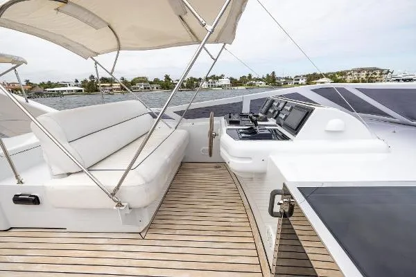  Yacht Photos Pics Luxurious 1999 Azimut yacht deck with seating and navigation controls, featuring elegant wood flooring.