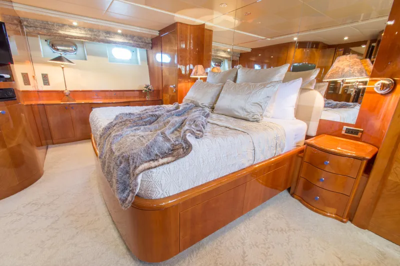  Yacht Photos Pics Luxurious bedroom in 1999 Azimut 5 Stateroom VIP Edition yacht with elegant wood finishes.