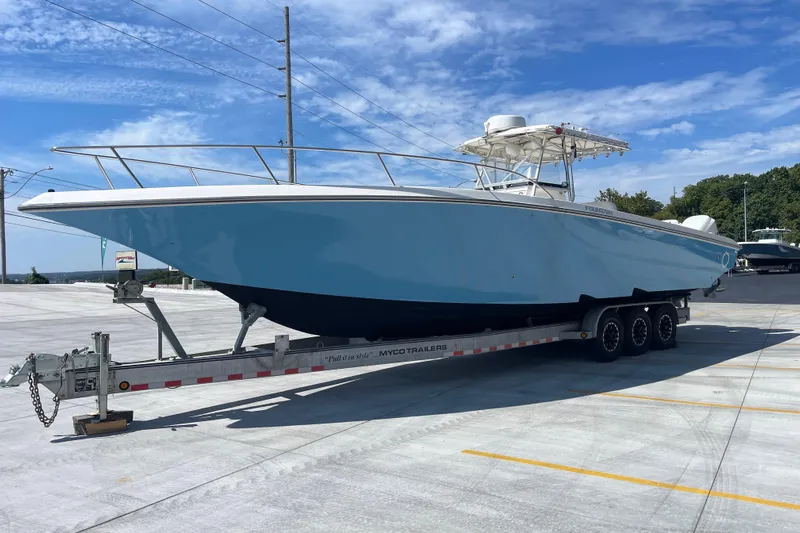  Yacht Photos Pics 2002 Fountain 38 CC Tournament Edition boat on trailer under clear blue sky.