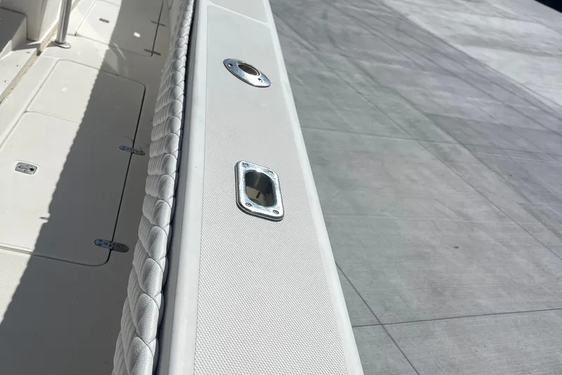  Yacht Photos Pics 2002 Fountain 38 CC Tournament Edition boat deck with rod holder and padded railing.