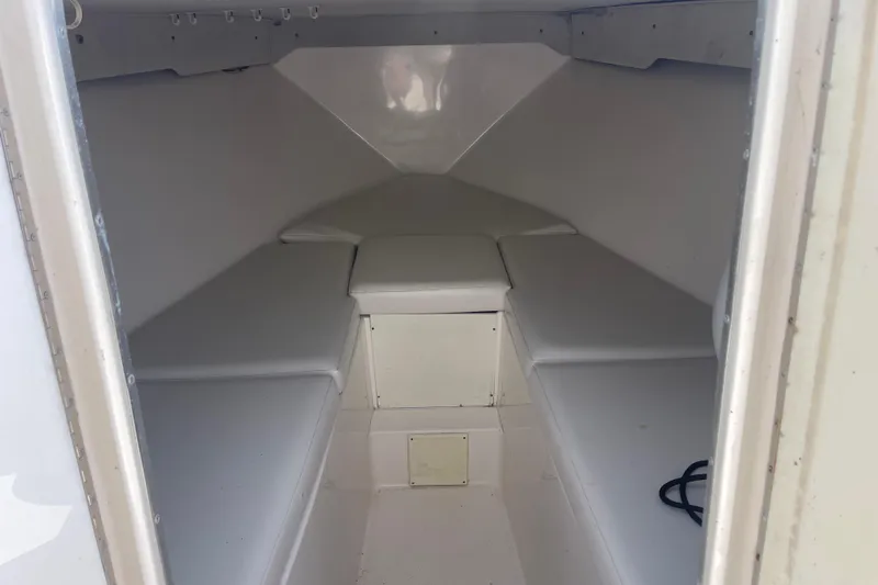  Yacht Photos Pics 2002 Fountain 38 CC Tournament Edition boat cabin interior with white cushioned seating.