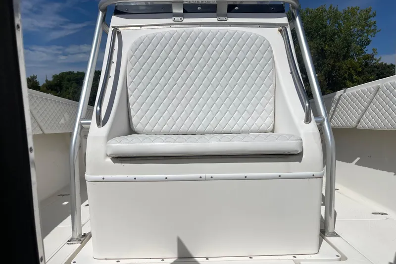  Yacht Photos Pics 2002 Fountain 38 CC Tournament Edition boat with white quilted seating and metal railings.