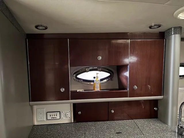  Yacht Photos Pics 2005 Formula 400 SS yacht interior with wooden cabinets and porthole window.