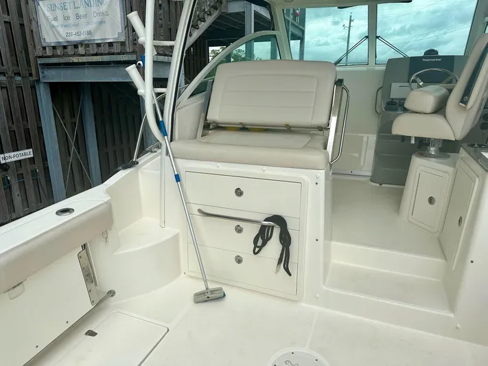 Thomfoolery II Yacht Photos Pics 2016 Boston Whaler 315 Conquest interior with seating and storage compartments.