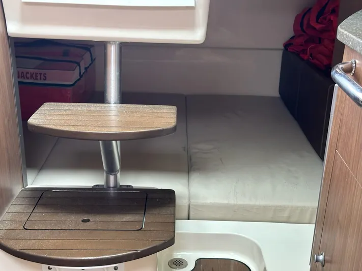 Thomfoolery II Yacht Photos Pics Interior cabin of 2016 Boston Whaler 315 Conquest with wooden steps and seating area.