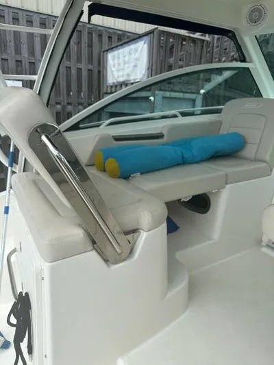 Thomfoolery II Yacht Photos Pics Interior of a 2016 Boston Whaler 315 Conquest boat with seating and cushions.