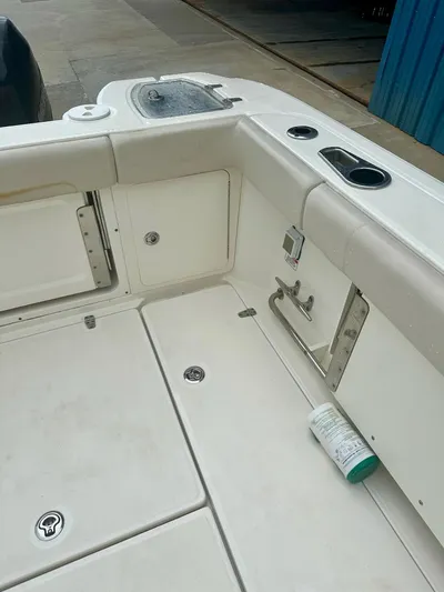 Thomfoolery II Yacht Photos Pics 2016 Boston Whaler 315 Conquest boat deck with storage compartments and cup holders.