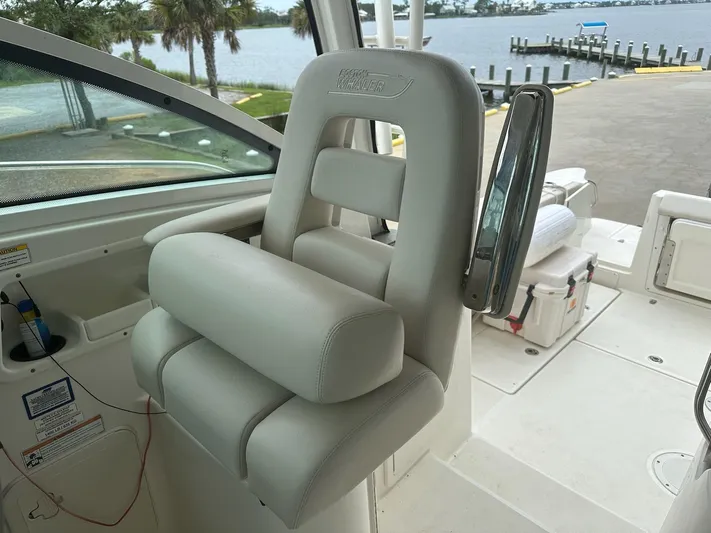 Thomfoolery II Yacht Photos Pics Captain's chair on 2016 Boston Whaler 315 Conquest boat, dockside view.