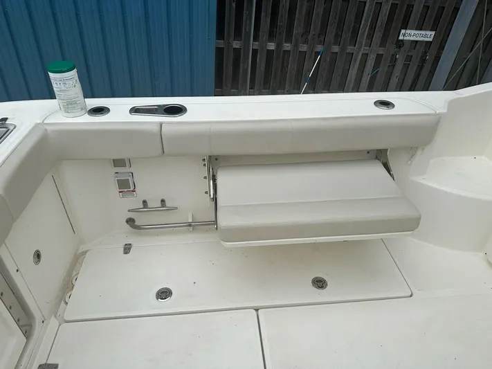 Thomfoolery II Yacht Photos Pics 2016 Boston Whaler 315 Conquest boat interior with foldable seat and cup holders.