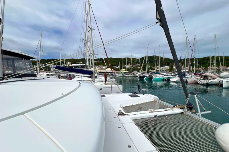 Mocean Yacht Photos Pics 2017 Lagoon 42 catamaran docked in a marina with other sailboats.
