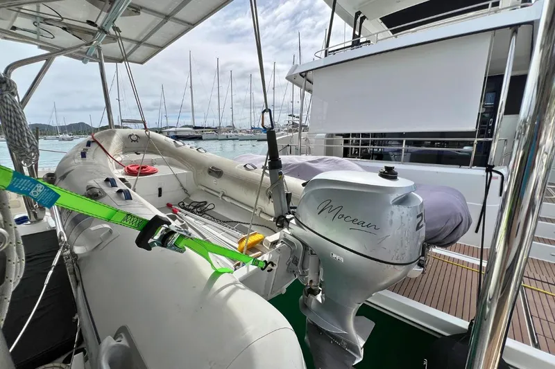 Mocean Yacht Photos Pics 2017 Lagoon 42 yacht with dinghy and outboard motor, docked at marina.