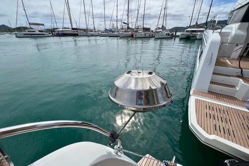 Mocean Yacht Photos Pics Lagoon 42 catamaran (2017) with a stainless steel grill, docked in a marina.