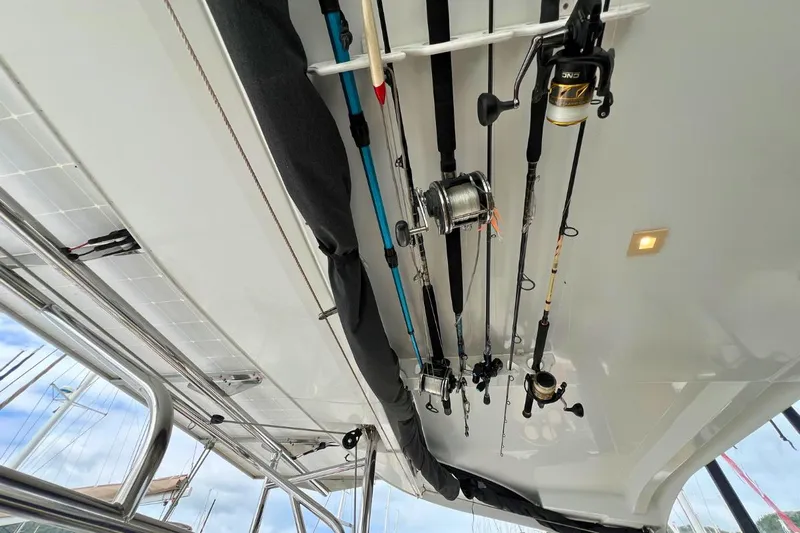 Mocean Yacht Photos Pics Fishing rods stored on a 2017 Lagoon 42 catamaran's ceiling, with visible sky and boat structure.