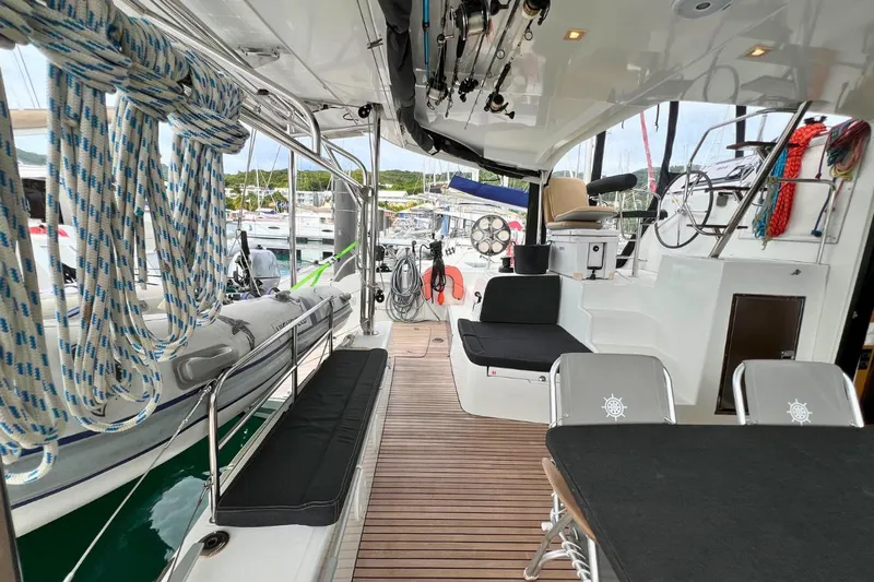Mocean Yacht Photos Pics Interior view of 2017 Lagoon 42 catamaran with seating, ropes, and steering wheel.