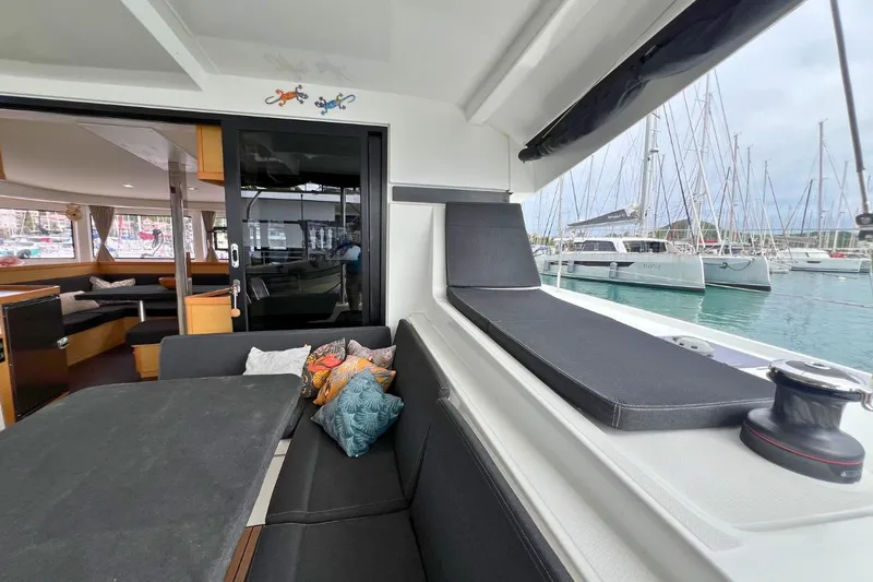 Mocean Yacht Photos Pics 2017 Lagoon 42 catamaran interior with seating area, docked at marina.