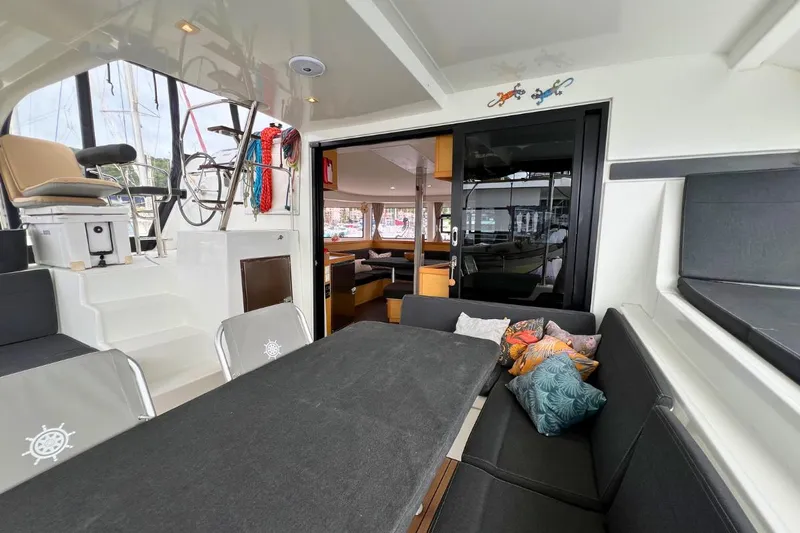 Mocean Yacht Photos Pics 2017 Lagoon 42 catamaran interior with seating, helm, and colorful cushions.