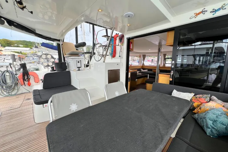 Mocean Yacht Photos Pics 2017 Lagoon 42 catamaran interior with seating, table, and nautical decor.