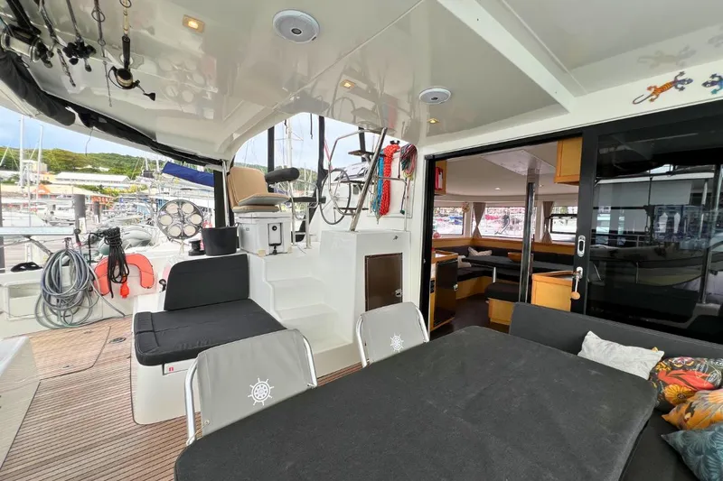 Mocean Yacht Photos Pics 2017 Lagoon 42 catamaran interior with seating, dining area, and helm station in a marina setting.