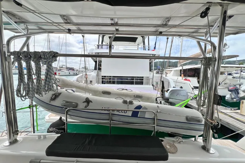 Mocean Yacht Photos Pics 2017 Lagoon 42 catamaran with dinghy, docked at marina, ropes neatly arranged.