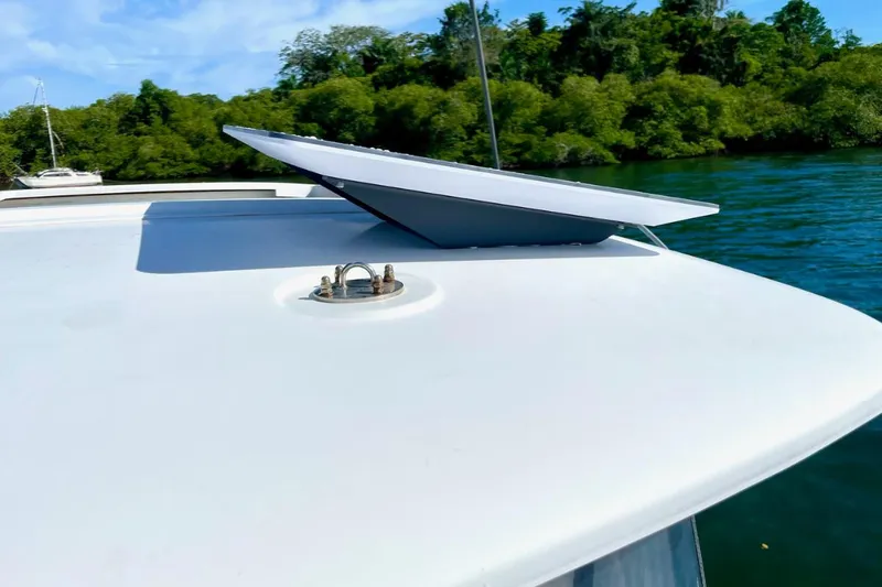 Mocean Yacht Photos Pics Rooftop solar panel on 2017 Lagoon 42 catamaran, surrounded by lush greenery and water.