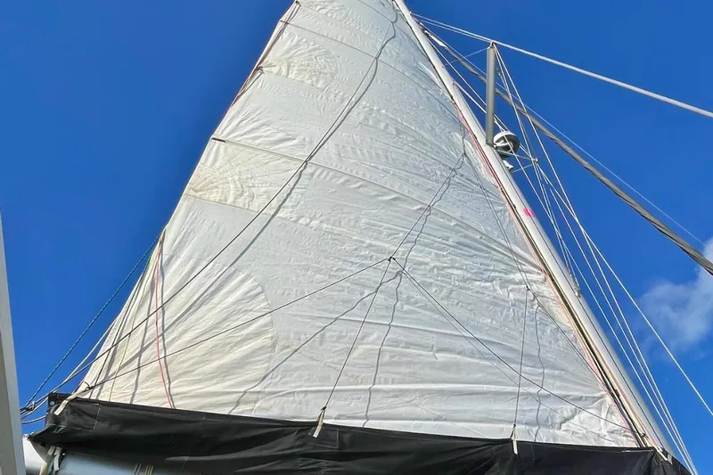 Mocean Yacht Photos Pics Sail of a 2017 Lagoon 42 catamaran against a clear blue sky.