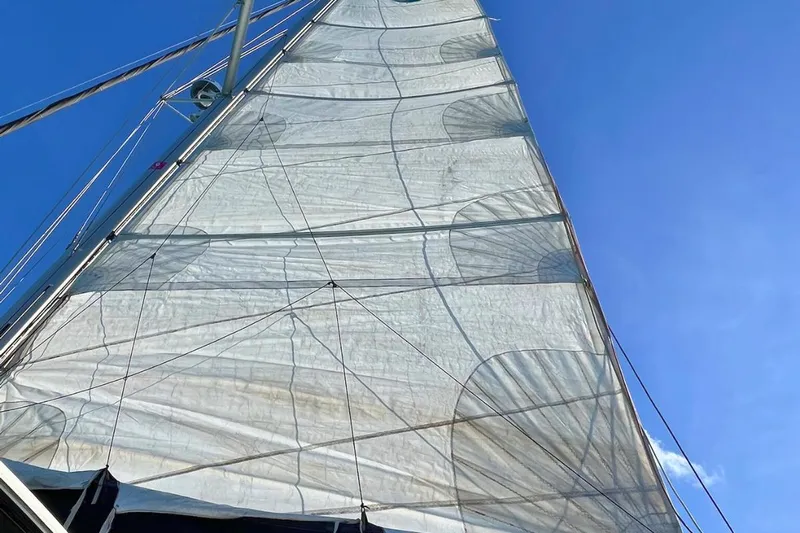 Mocean Yacht Photos Pics Sail of a 2017 Lagoon 42 catamaran against a clear blue sky.