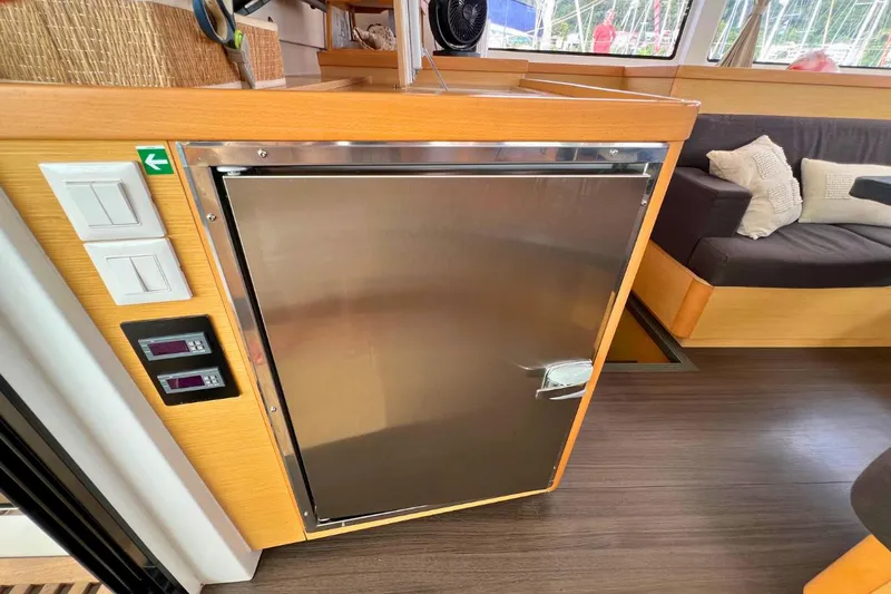 Mocean Yacht Photos Pics Interior of 2017 Lagoon 42 yacht featuring a stainless steel fridge and cozy seating area.