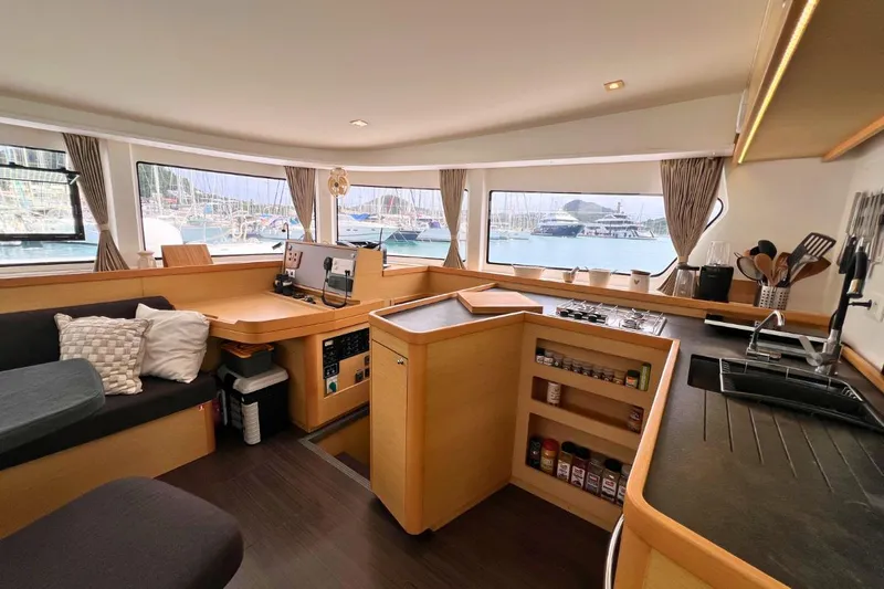 Mocean Yacht Photos Pics Interior of 2017 Lagoon 42 catamaran with spacious seating and modern kitchen area.