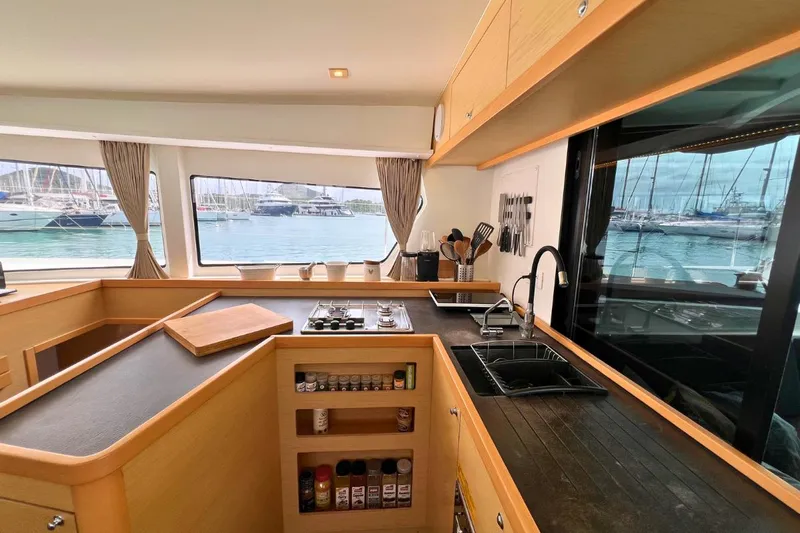 Mocean Yacht Photos Pics Interior of 2017 Lagoon 42 yacht kitchen with modern amenities and marina view.
