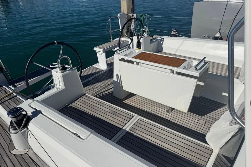  Yacht Photos Pics 2023 Beneteau Oceanis 38.1 yacht cockpit with dual steering wheels and teak flooring.