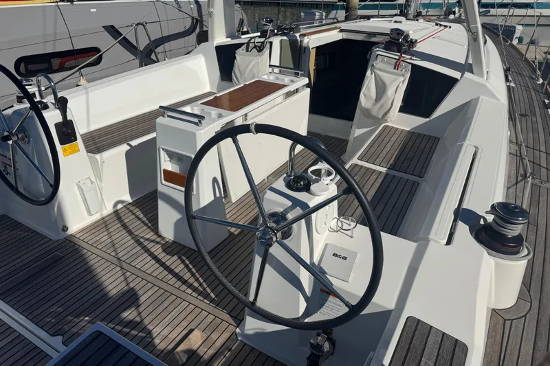  Yacht Photos Pics 2023 Beneteau Oceanis 38.1 yacht cockpit with dual steering wheels and teak decking.