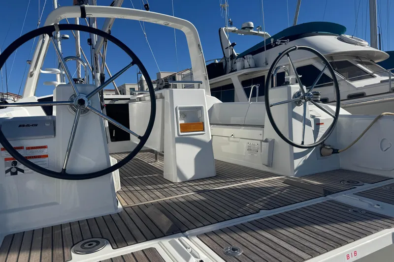  Yacht Photos Pics 2023 Beneteau Oceanis 38.1 yacht cockpit with dual steering wheels and teak decking.