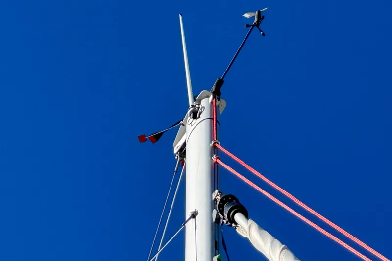  Yacht Photos Pics Mast of 2023 Beneteau Oceanis 38.1 sailboat against clear blue sky.