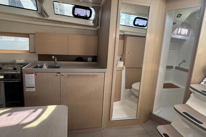  Yacht Photos Pics Interior of 2023 Beneteau Oceanis 38.1 yacht, featuring modern kitchen and bathroom.
