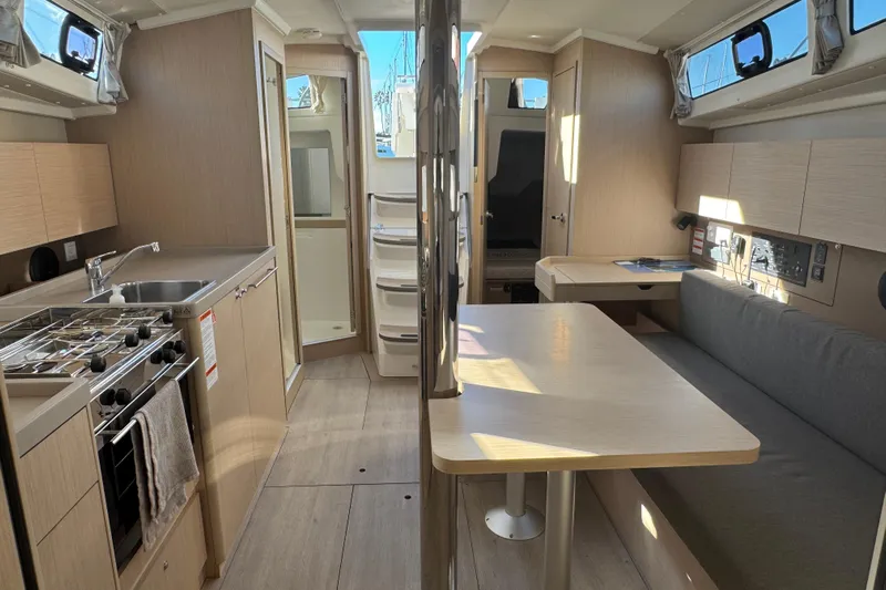  Yacht Photos Pics Interior of 2023 Beneteau Oceanis 38.1 yacht, featuring modern kitchen and dining area.