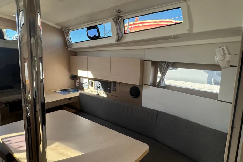  Yacht Photos Pics Interior of 2023 Beneteau Oceanis 38.1 yacht, featuring modern seating and windows.