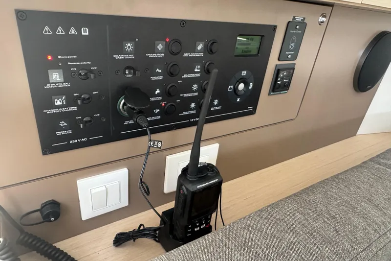  Yacht Photos Pics Control panel of 2023 Beneteau Oceanis 38.1 yacht with radio and switches.