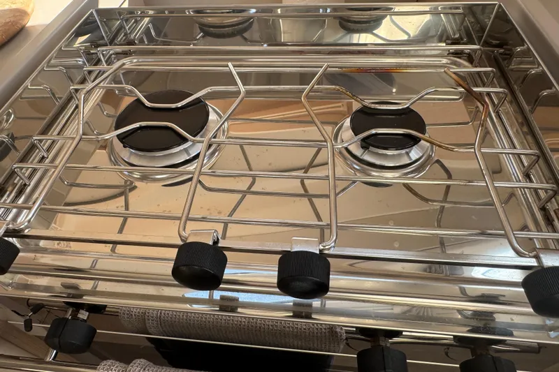  Yacht Photos Pics Stainless steel stove on 2023 Beneteau Oceanis 38.1 yacht, featuring dual burners.