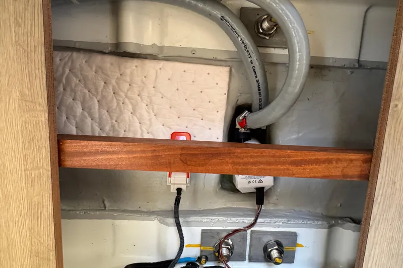  Yacht Photos Pics Interior view of 2023 Beneteau Oceanis 38.1 yacht showing wiring and plumbing components.