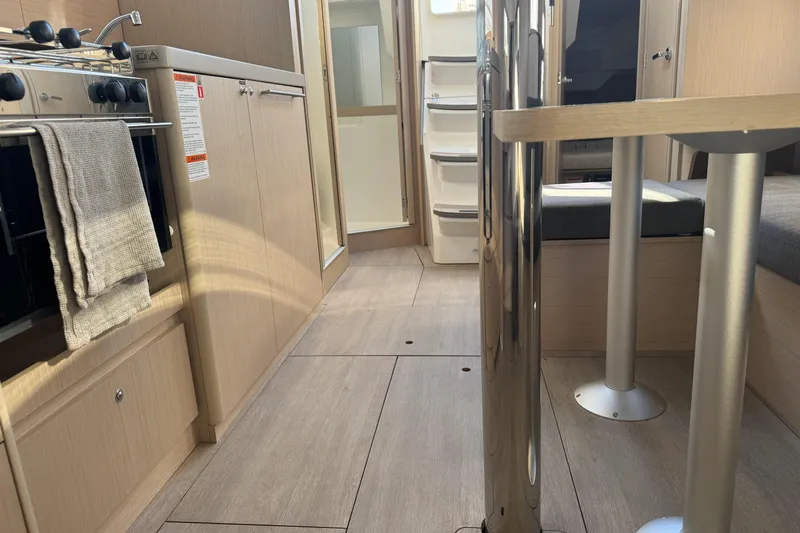  Yacht Photos Pics Interior of 2023 Beneteau Oceanis 38.1 yacht, featuring modern kitchen and dining area.