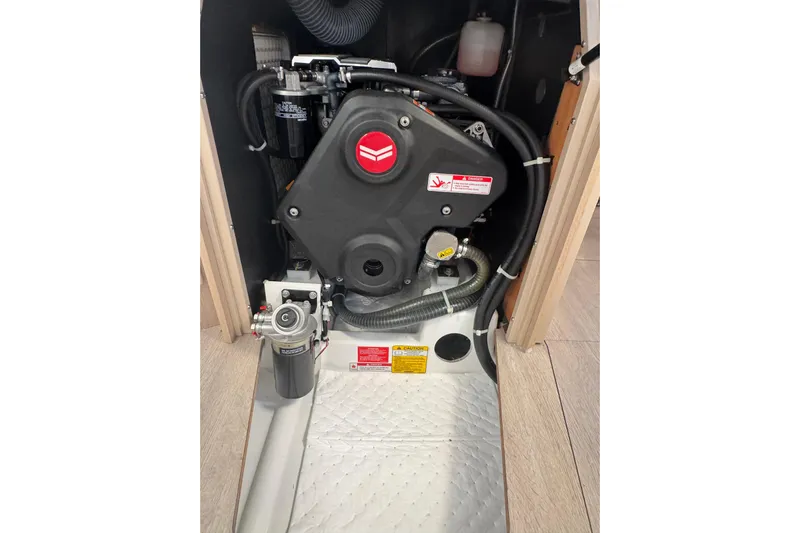  Yacht Photos Pics Engine compartment of 2023 Beneteau Oceanis 38.1 sailboat, showcasing mechanical components.