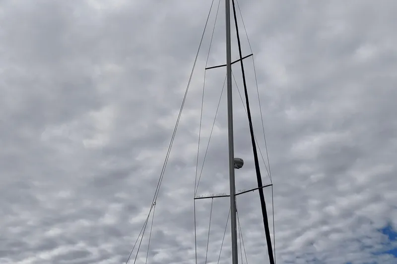 Rendez-vous Yacht Photos Pics Mast of a 2003 Catalina 387 sailboat against a cloudy sky.